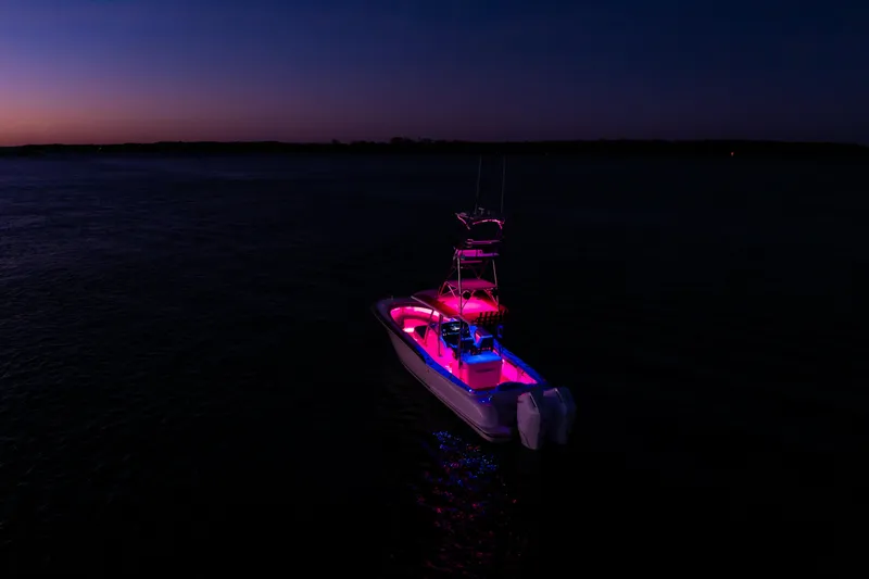 Toto II Yacht Photos Pics 2019 Mag Bay 33 CC boat illuminated at night on calm water.