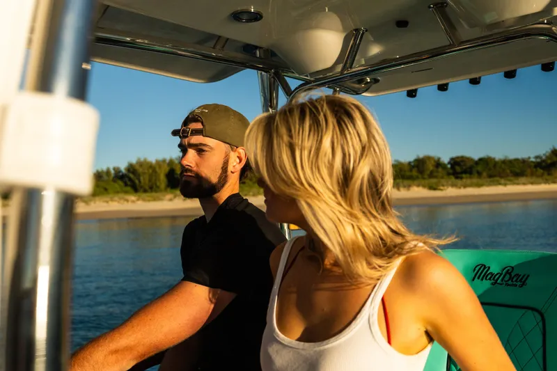Toto II Yacht Photos Pics Couple enjoying a ride on a 2019 Mag Bay 33 CC boat.