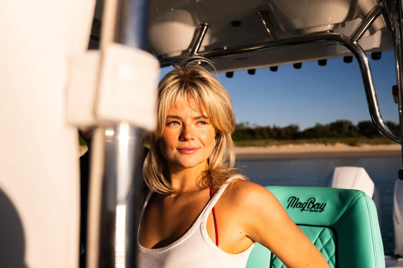 Toto II Yacht Photos Pics Woman enjoying a sunny day on a 2019 Mag Bay 33 CC boat.