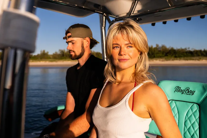 Toto II Yacht Photos Pics Couple enjoying a sunny day on a 2019 Mag Bay 33 CC boat.