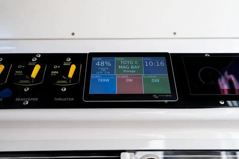 Toto II Yacht Photos Pics Control panel of a 2019 Mag Bay 33 CC boat displaying battery and system status.