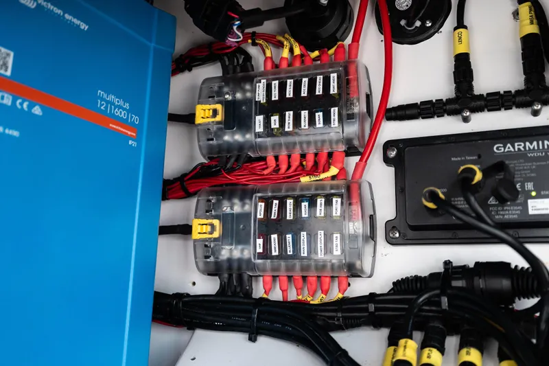 Toto II Yacht Photos Pics Electrical system components in a 2019 Mag Bay 33 CC boat, featuring wiring and control panels.