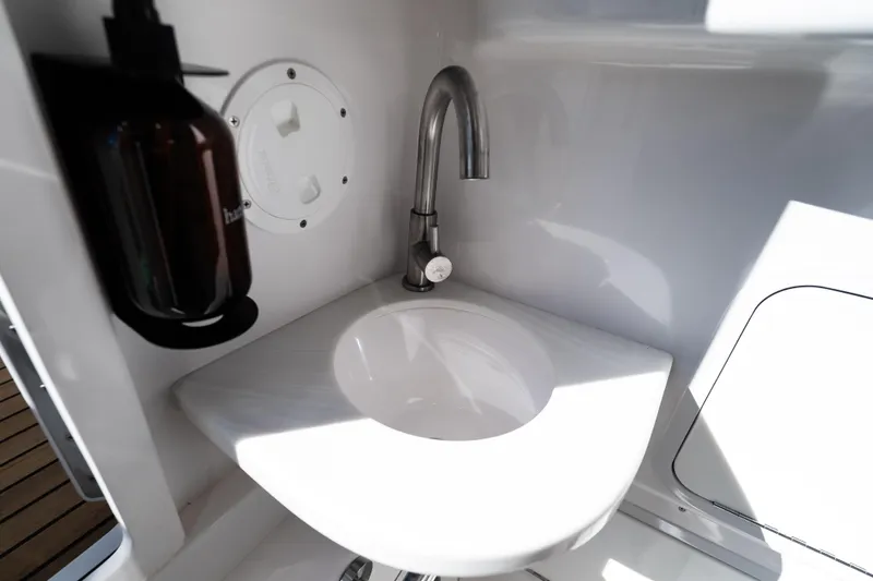 Toto II Yacht Photos Pics 2019 Mag Bay 33 CC boat interior sink with faucet and soap dispenser.