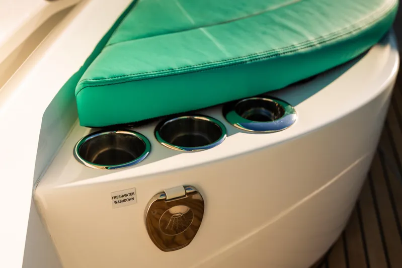 Toto II Yacht Photos Pics 2019 Mag Bay 33 CC boat with green cushion and cup holders.