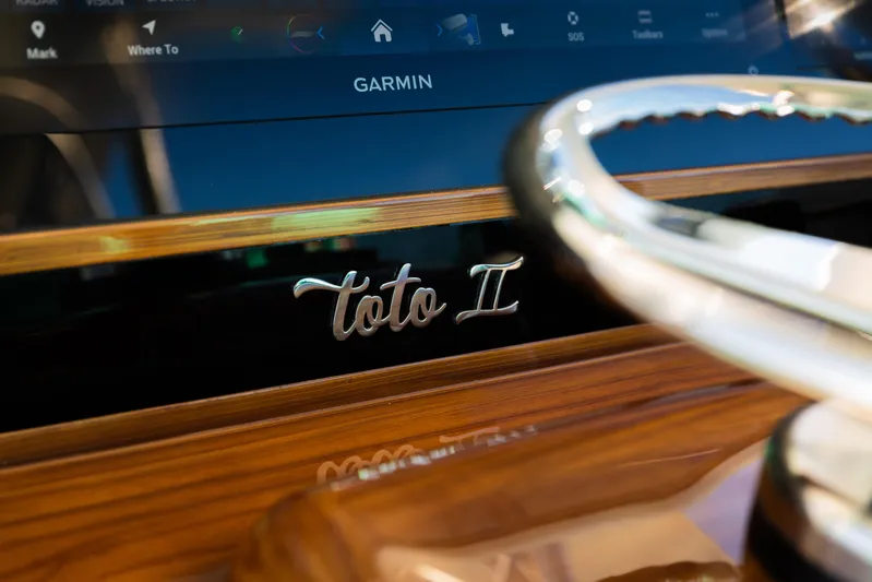 Toto II Yacht Photos Pics 2019 Mag Bay 33 CC dashboard with Garmin display and "Toto II" nameplate.