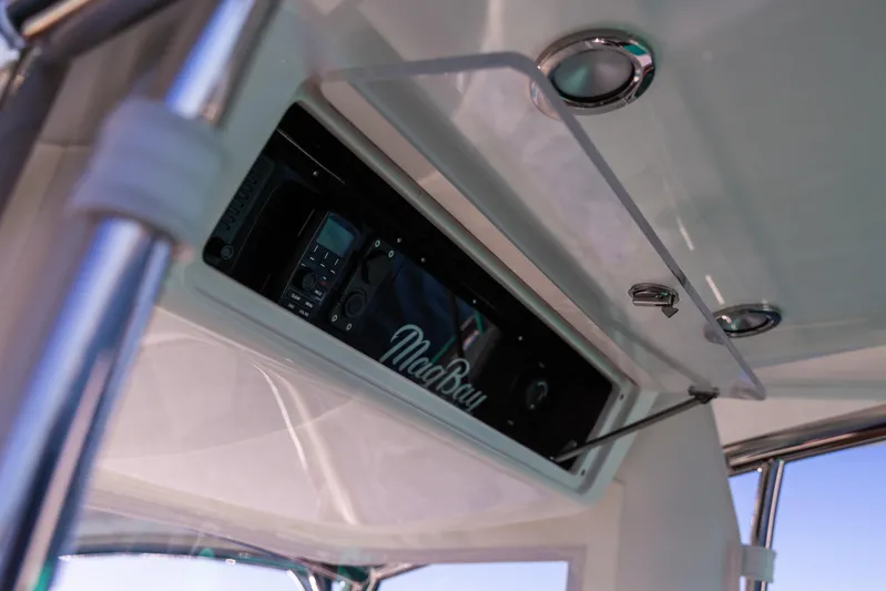 Toto II Yacht Photos Pics 2019 Mag Bay 33 CC boat console with electronics and storage compartment.