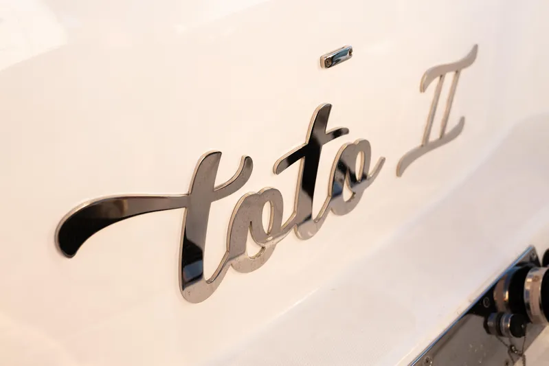 Toto II Yacht Photos Pics Close-up of 'Toto II' nameplate on 2019 Mag Bay 33 CC boat.