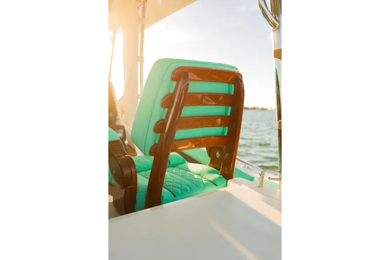 Toto II Yacht Photos Pics Luxurious seating on 2019 Mag Bay 33 CC boat with turquoise cushions and wooden accents.