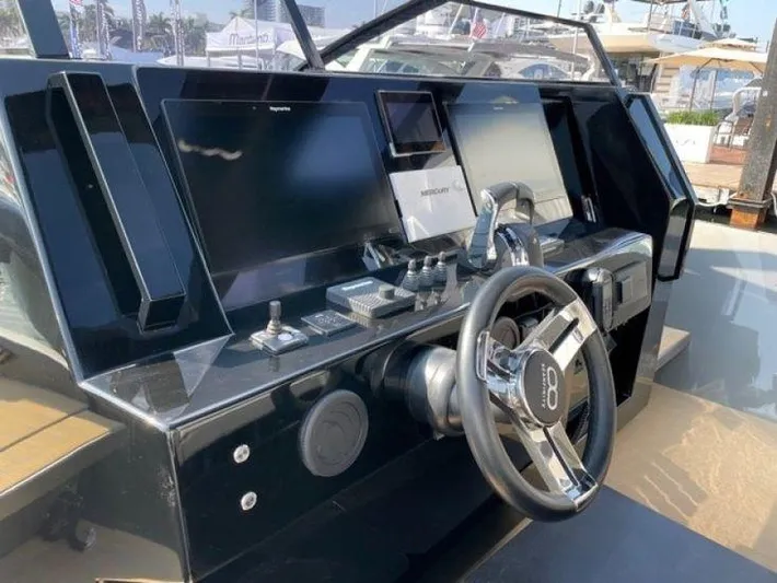Seafinity Yacht Photos Pics Control panel of 2019 Seanfinity TS48 yacht with steering wheel and navigation screens.