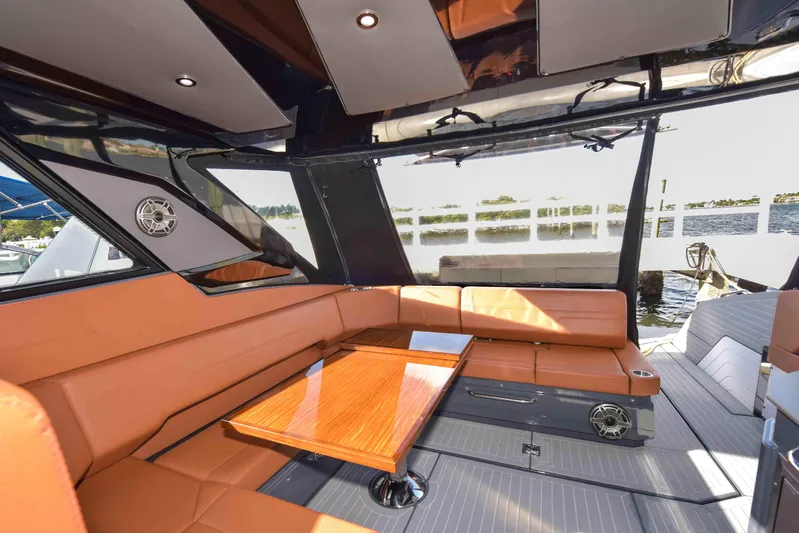 Sea Ya Later Yacht Photos Pics Luxurious interior of 2021 Cruisers Yachts 42 GLS OB with leather seating and wooden table.