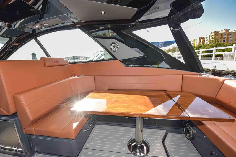 Sea Ya Later Yacht Photos Pics Luxurious interior of 2021 Cruisers Yachts 42 GLS OB with leather seating and wooden table.