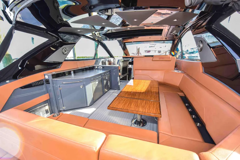 Sea Ya Later Yacht Photos Pics Luxurious interior of 2021 Cruisers Yachts 42 GLS OB with leather seating and wooden table.