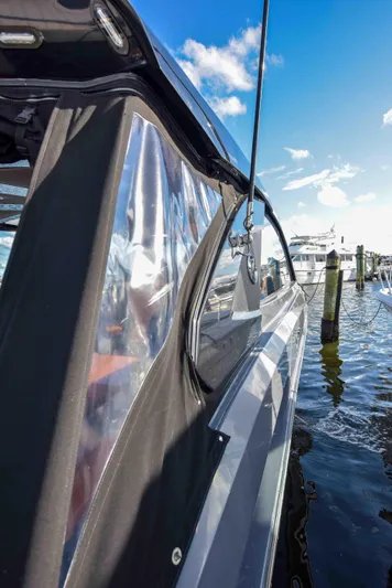 Sea Ya Later Yacht Photos Pics 2021 Cruisers Yachts 42 GLS OB docked, showcasing sleek design and clear canopy under blue sky.