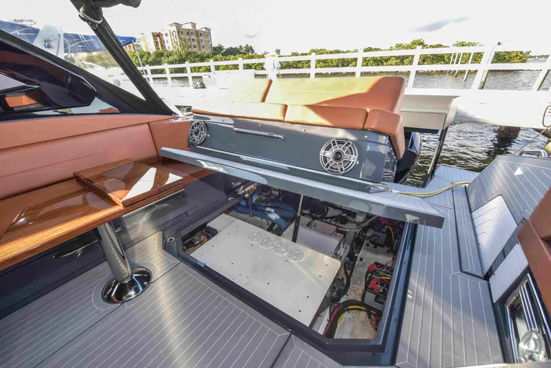 Sea Ya Later Yacht Photos Pics 2021 Cruisers Yachts 42 GLS OB with open engine compartment, docked by the water.