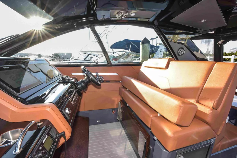 Sea Ya Later Yacht Photos Pics 2021 Cruisers Yachts 42 GLS OB interior with luxurious seating and modern dashboard.