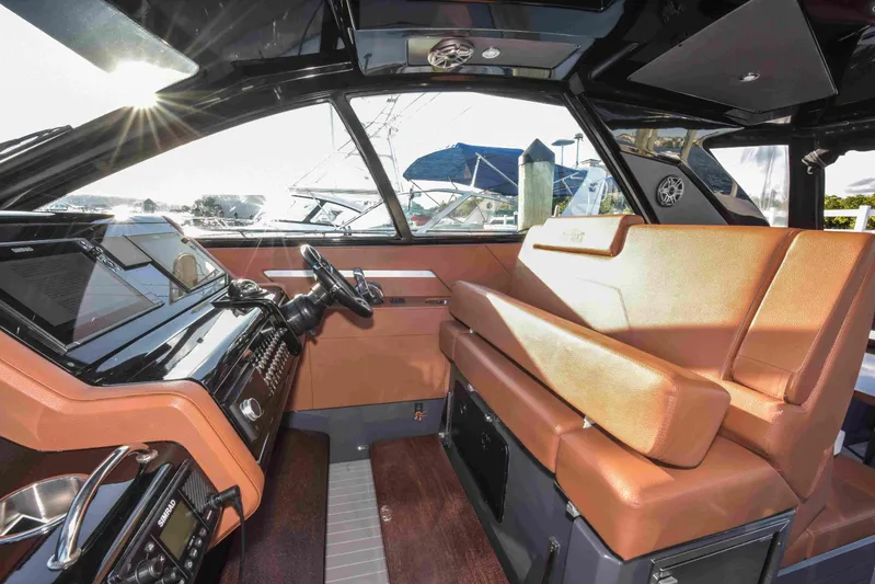 Sea Ya Later Yacht Photos Pics 2021 Cruisers Yachts 42 GLS OB interior with luxurious seating and modern dashboard.