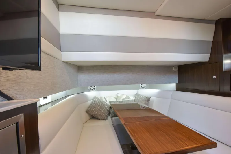 Sea Ya Later Yacht Photos Pics 2021 Cruisers Yachts 42 GLS OB interior with elegant seating and wooden table.