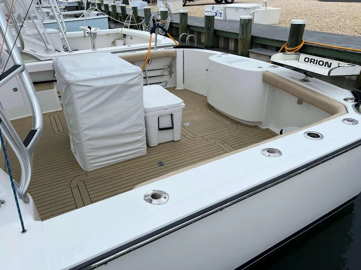  Yacht Photos Pics 2021 Henriques 42 Express Hardtop Bridge boat deck with seating and storage.