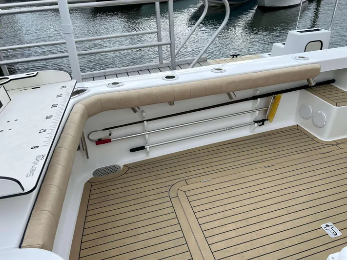  Yacht Photos Pics 2021 Henriques 42 Express Hardtop Bridge boat deck with rod holders and teak flooring.