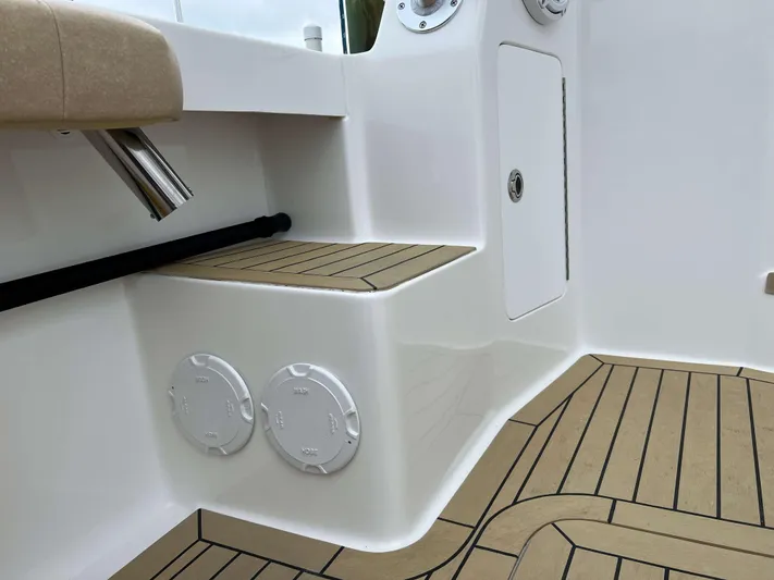  Yacht Photos Pics 2021 Henriques 42 Express Hardtop Bridge interior with teak flooring and storage compartments.