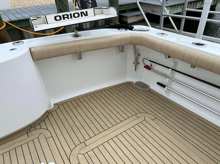  Yacht Photos Pics 2021 Henriques 42 Express Hardtop Bridge boat deck with teak flooring and fishing rod holders.