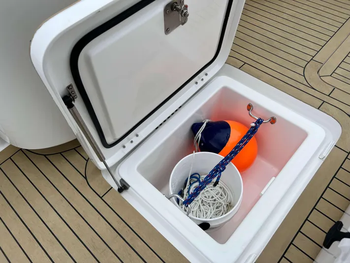  Yacht Photos Pics Storage compartment on 2021 Henriques 42 Express Hardtop Bridge with ropes and buoy.