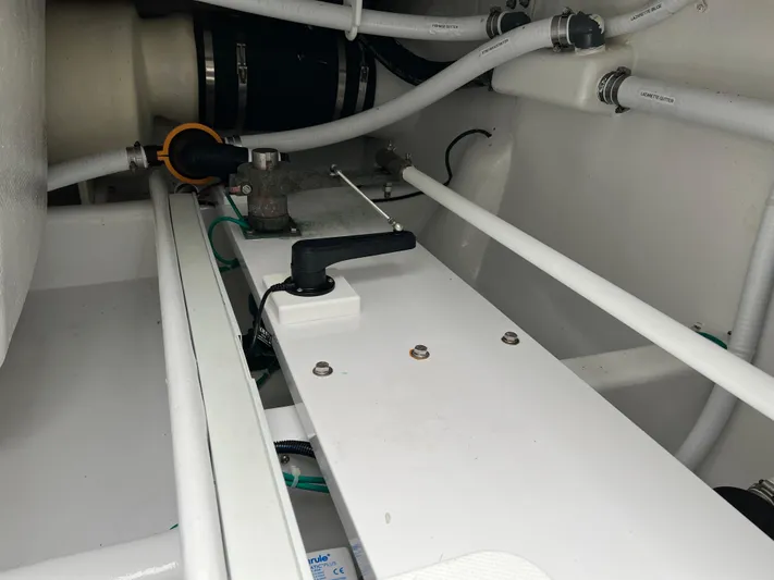  Yacht Photos Pics Engine compartment of 2021 Henriques 42 Express Hardtop Bridge with visible pipes and components.