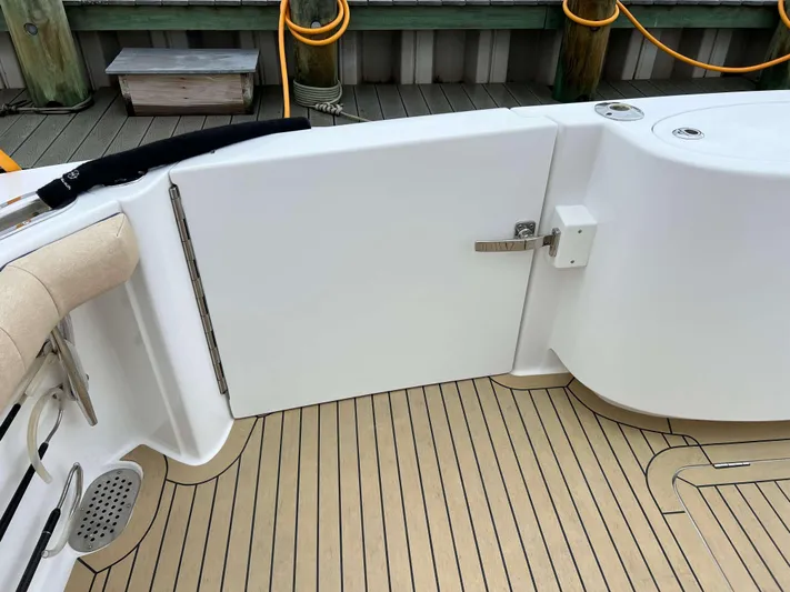  Yacht Photos Pics Henriques 42 Express Hardtop Bridge 2021, deck view with teak flooring and white door.