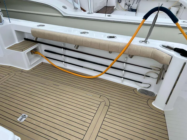  Yacht Photos Pics 2021 Henriques 42 Express Hardtop Bridge deck with rod holders and hose.