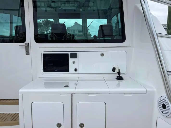  Yacht Photos Pics 2021 Henriques 42 Express Hardtop Bridge yacht interior with sleek white cabinetry.