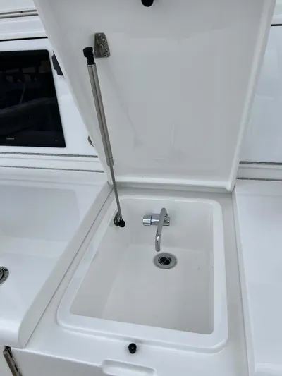  Yacht Photos Pics 2021 Henriques 42 Express Hardtop Bridge sink with open lid and faucet.