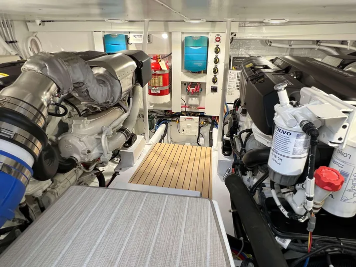  Yacht Photos Pics Engine room of 2021 Henriques 42 Express Hardtop Bridge, featuring dual engines and modern equipment.