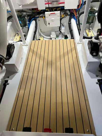  Yacht Photos Pics Engine room of 2021 Henriques 42 Express Hardtop Bridge with teak flooring and visible wiring.