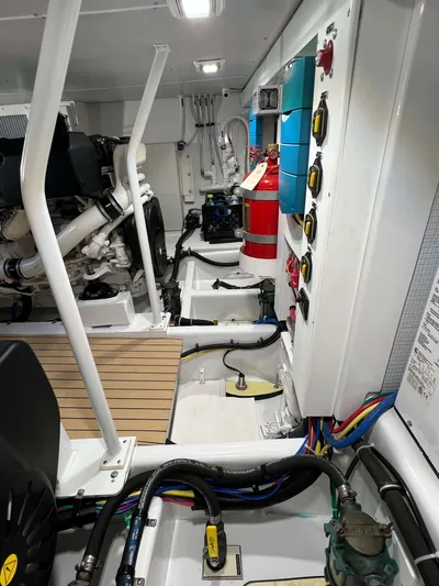  Yacht Photos Pics Engine room of 2021 Henriques 42 Express Hardtop Bridge with control panels and fire extinguisher.