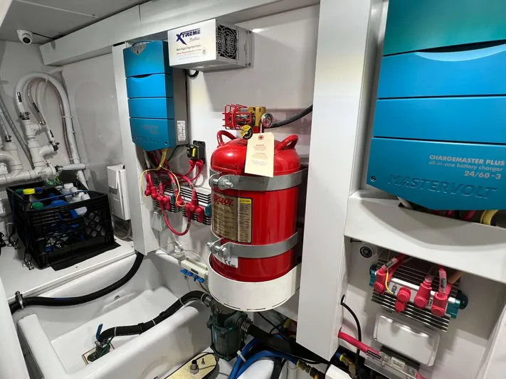  Yacht Photos Pics Engine room of 2021 Henriques 42 Express Hardtop Bridge with fire extinguisher and electrical systems.