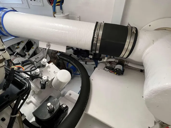  Yacht Photos Pics Engine room of 2021 Henriques 42 Express Hardtop Bridge, showcasing mechanical components and piping.