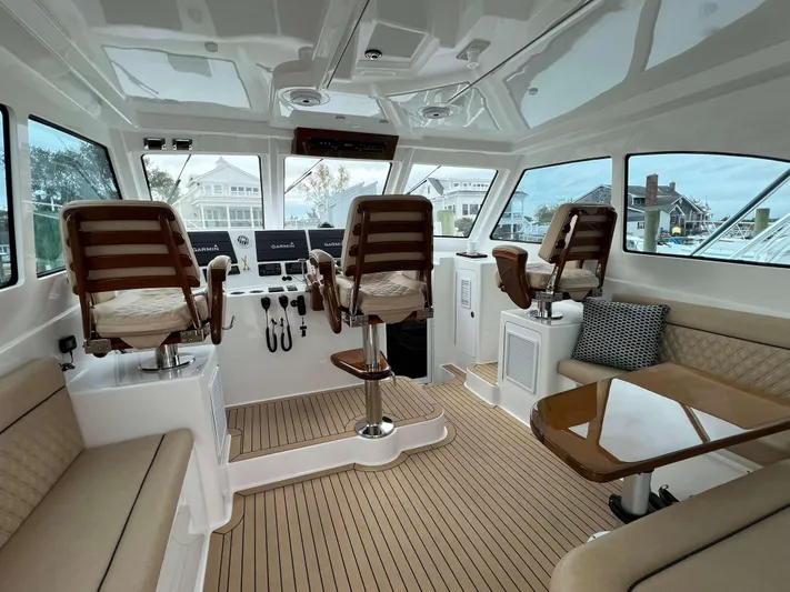  Yacht Photos Pics Interior of 2021 Henriques 42 Express Hardtop Bridge with luxurious seating and helm.