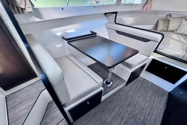 2022 Stamas 370 Aegean interior with modern seating and table arrangement.