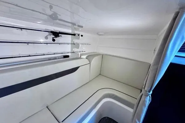 Seanior Moment Yacht Photos Pics 2022 Stamas 370 Aegean cabin interior with seating and fishing rod storage.
