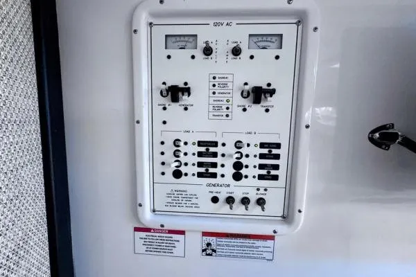 Seanior Moment Yacht Photos Pics Electrical control panel on 2022 Stamas 370 Aegean boat, featuring switches and gauges.