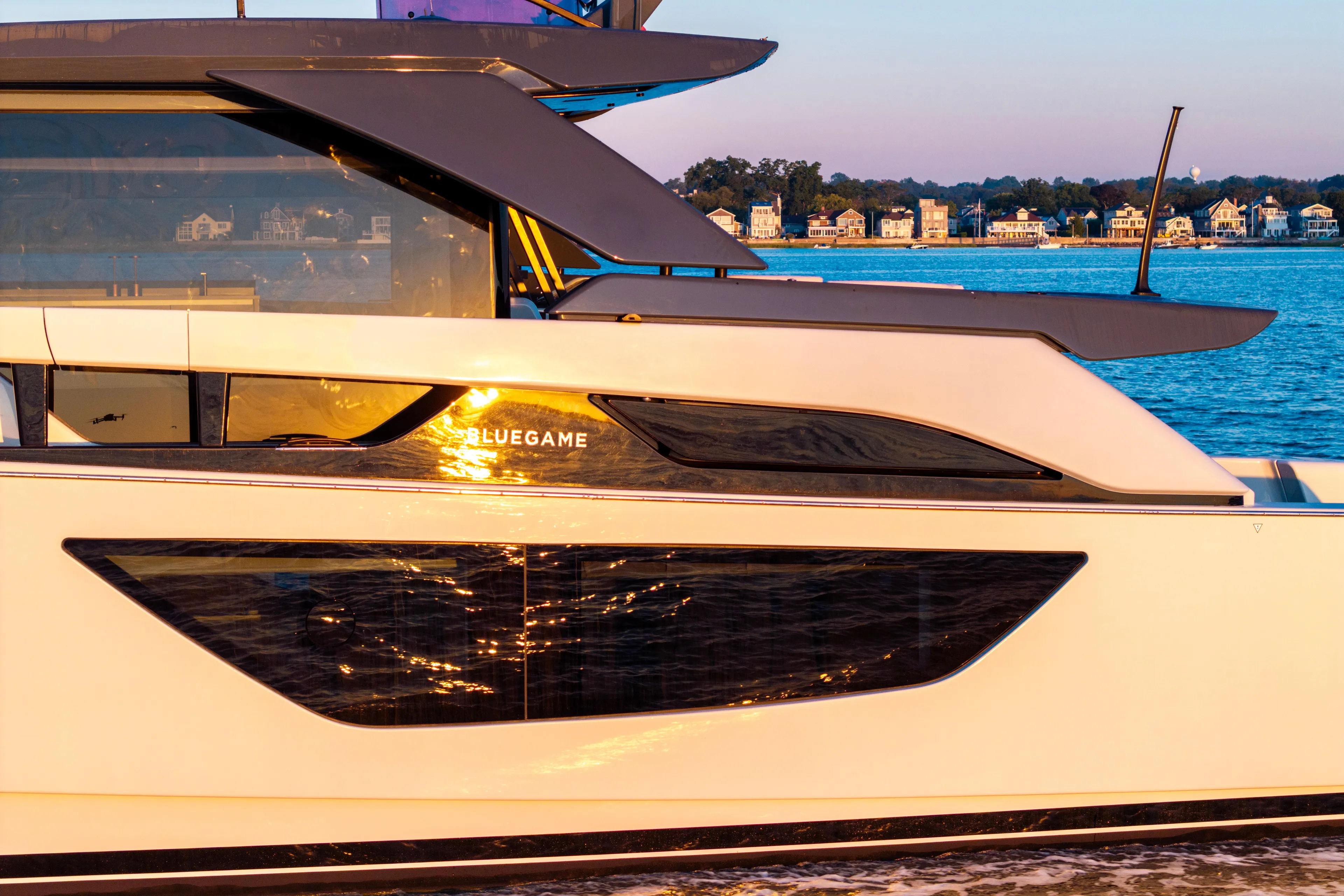 The Calm Down Yacht Photos Pics 2024 Bluegame BGX63 yacht on water at sunset, modern design, coastal background.