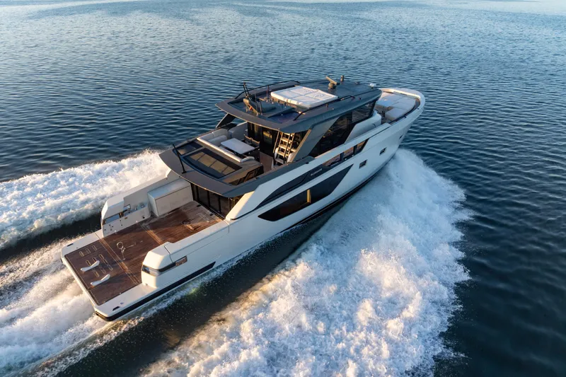 The Calm Down Yacht Photos Pics 2024 Bluegame BGX63 yacht cruising on open water, showcasing sleek design and luxury features.