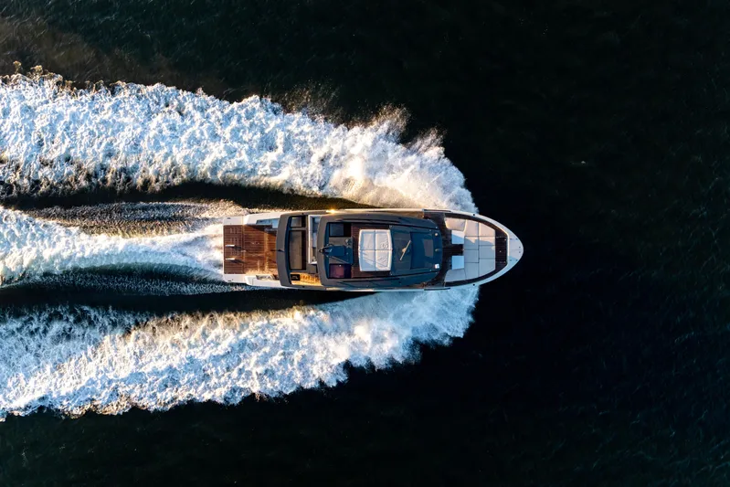 The Calm Down Yacht Photos Pics Aerial view of 2024 Bluegame BGX63 yacht cruising on open water.