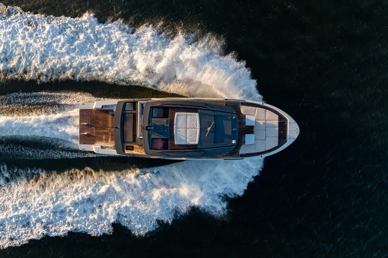 The Calm Down Yacht Photos Pics Aerial view of 2024 Bluegame BGX63 yacht cruising on open water.