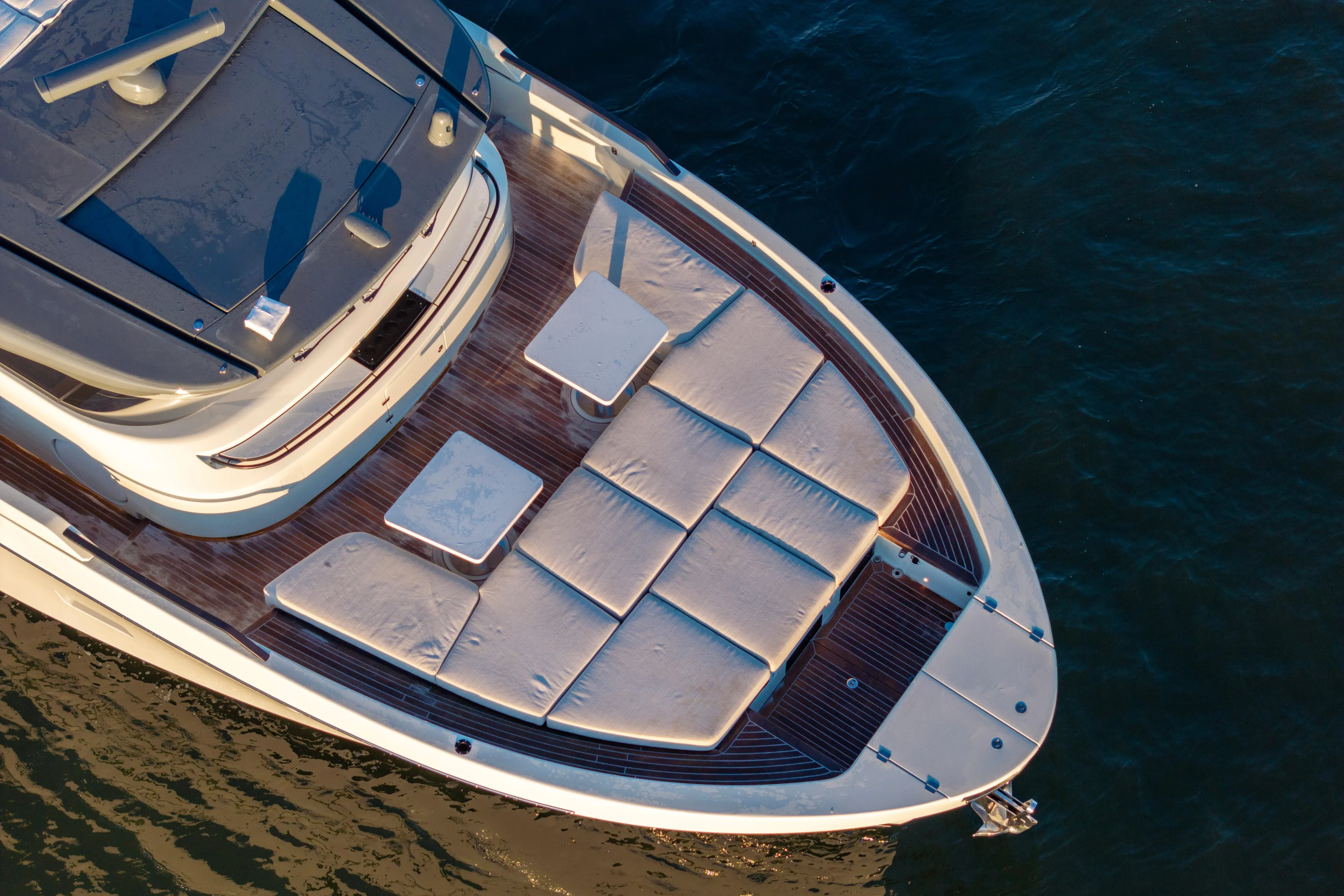 The Calm Down Yacht Photos Pics 2024 Bluegame BGX63 yacht deck with sun loungers and tables, aerial view.