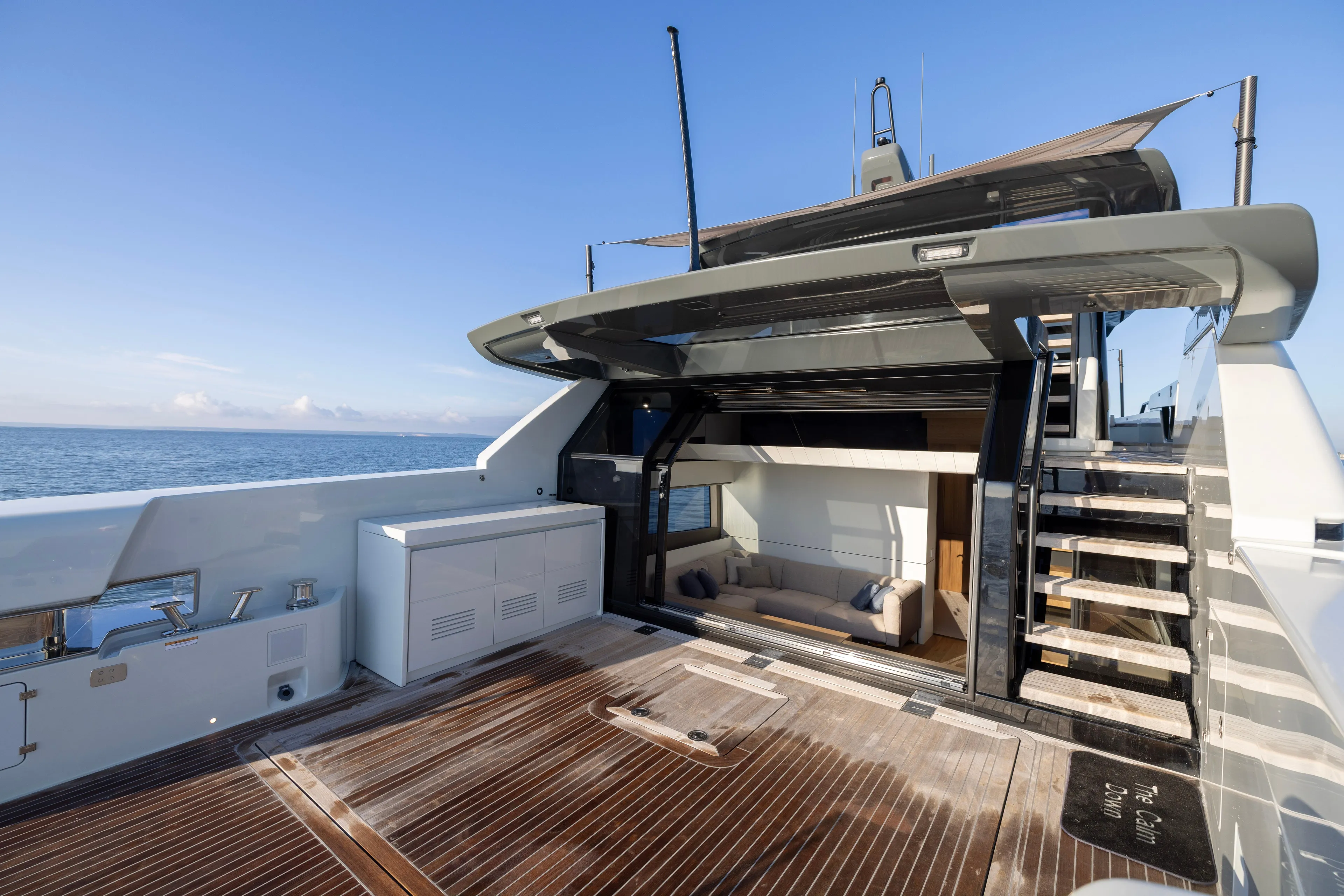 The Calm Down Yacht Photos Pics 2024 Bluegame BGX63 yacht deck with modern seating and ocean view.