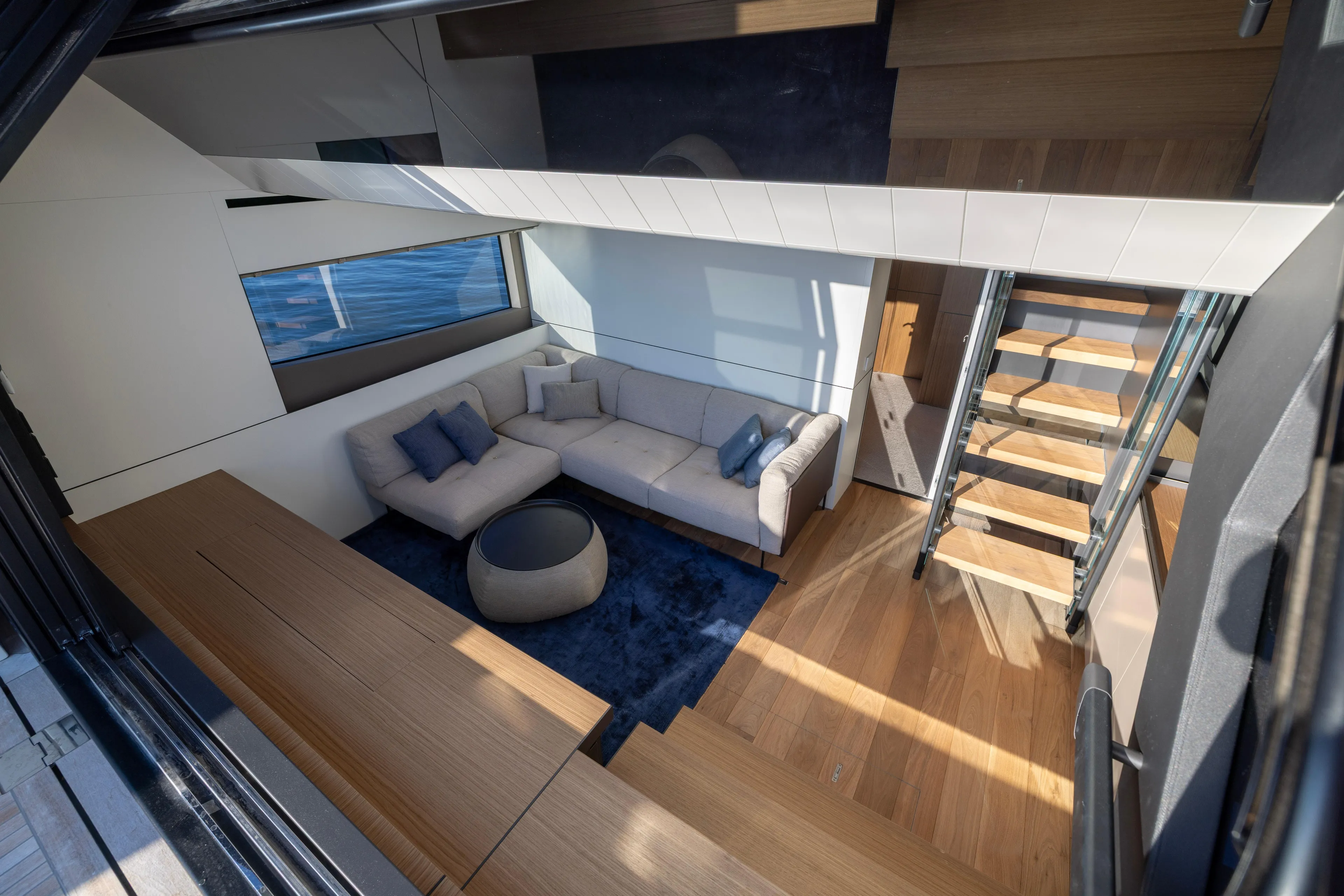 The Calm Down Yacht Photos Pics Luxurious interior of 2024 Bluegame BGX63 yacht with modern design and cozy seating area.