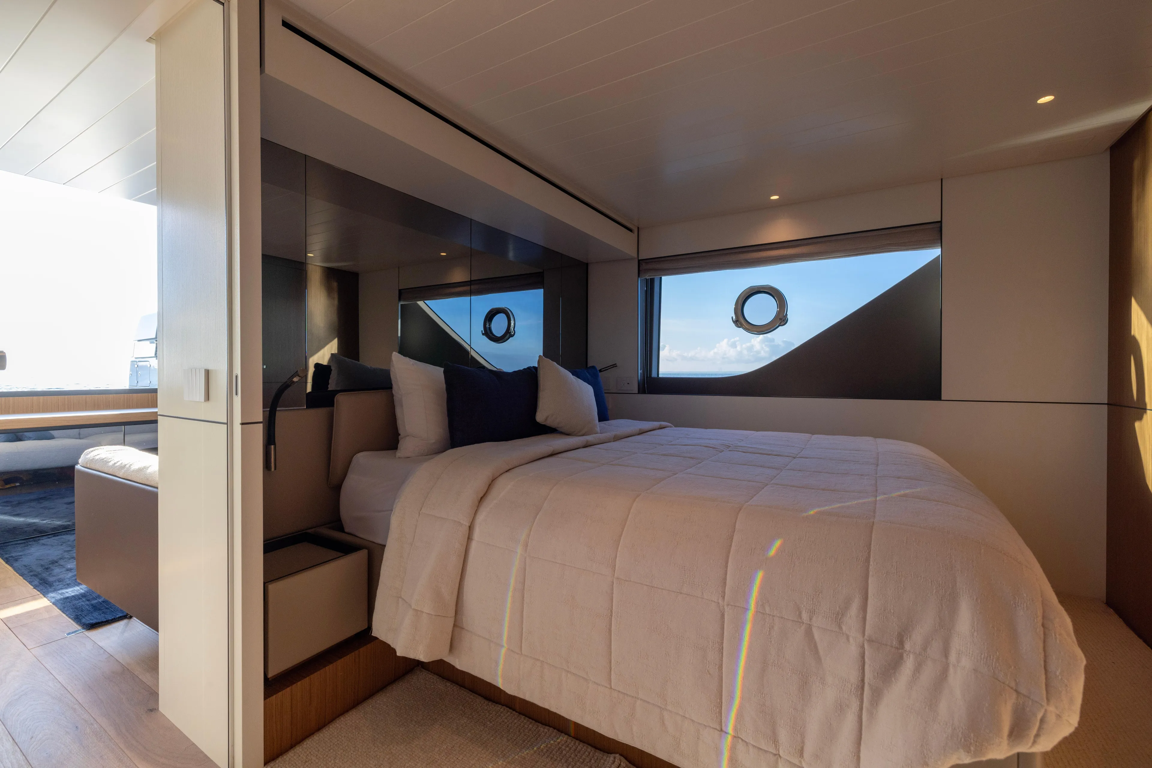 The Calm Down Yacht Photos Pics Luxurious bedroom interior of 2024 Bluegame BGX63 yacht with modern design and ocean view.