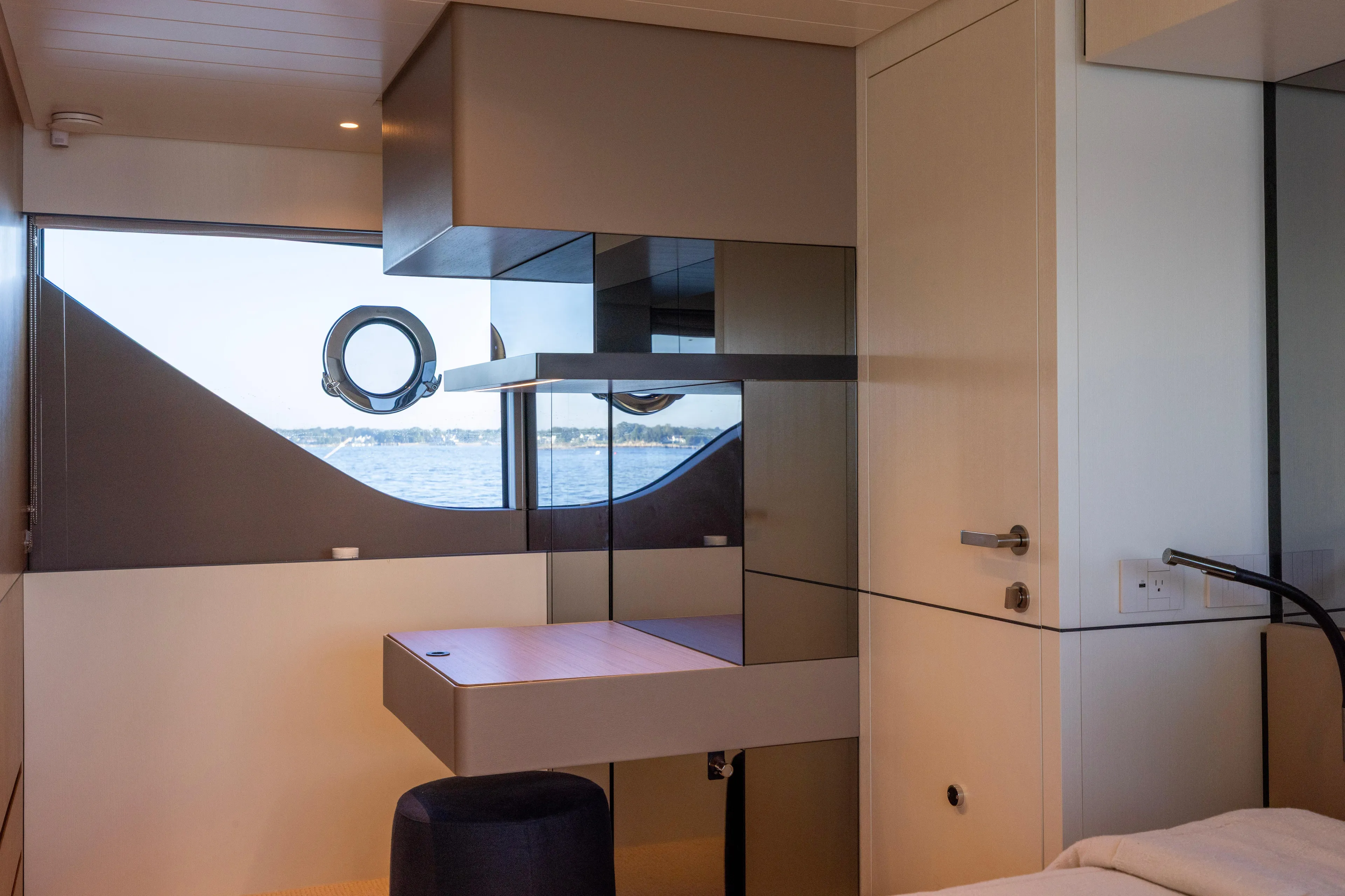 The Calm Down Yacht Photos Pics Interior of 2024 Bluegame BGX63 yacht, featuring modern design and ocean view through porthole.