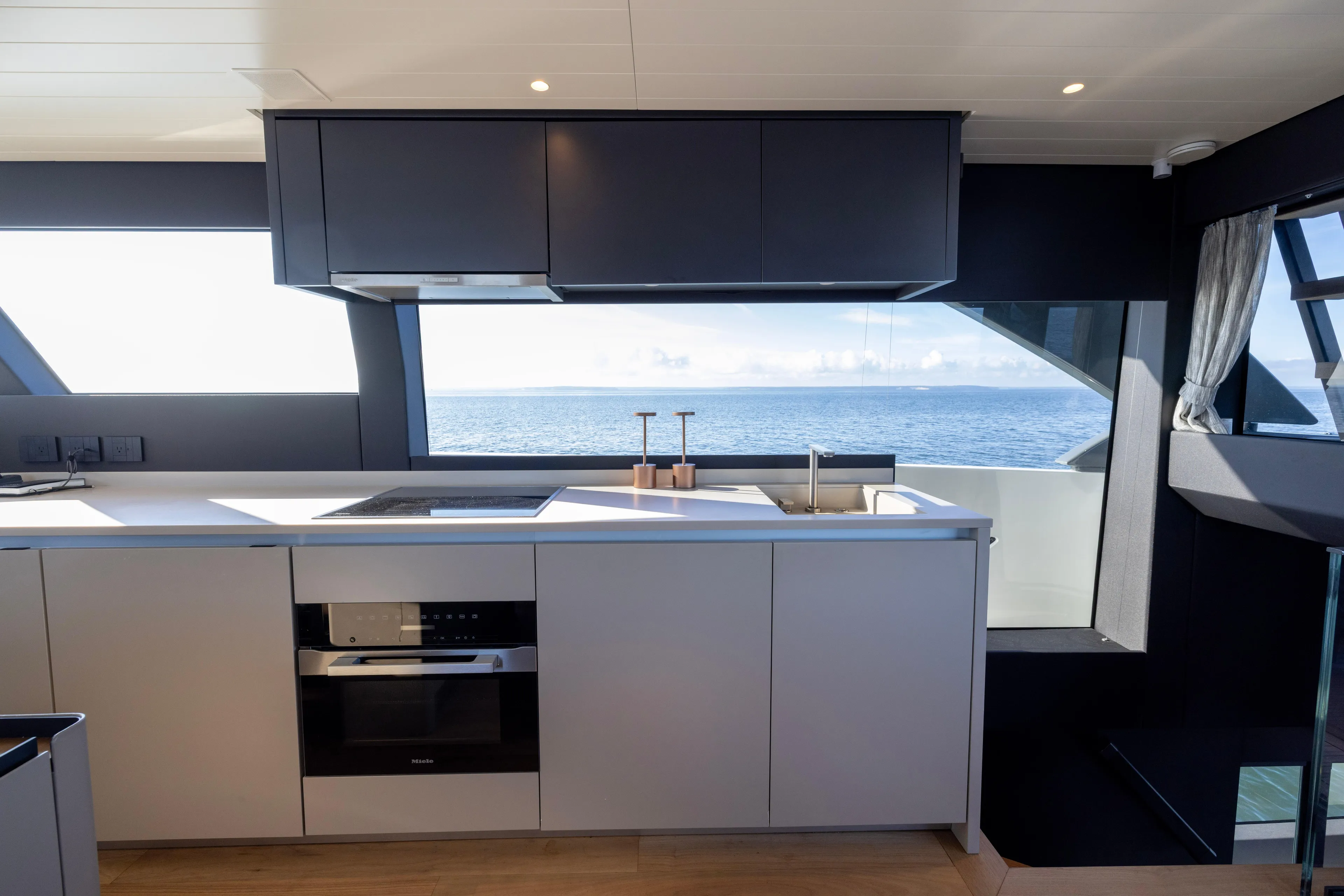 The Calm Down Yacht Photos Pics Modern kitchen interior on 2024 Bluegame BGX63 yacht with ocean view.